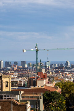Aerial panorama of the city of Barcelona with a construction crane