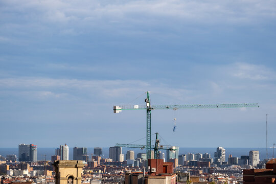 Aerial panorama of the city of Barcelona with a construction crane