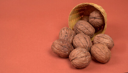 Closeup photo of a walnut seed in wooden bowl. Food that is good for brain and lower risk of heart disease.