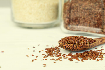 a scattering of flax seeds in a wooden spoon in the kitchen