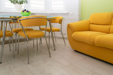 double cozy yellow fabric sofa. Interior design. classic and modern kitchen