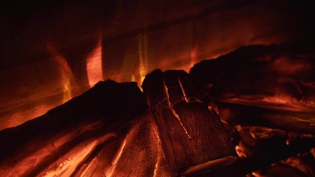 Fire is burning in the fireplace. Christmas Hearth. Warmth and home comfort. 