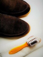 Men's  shoes and a brush for shoes on a light background. Leather shoe care, men's shoe cleaning