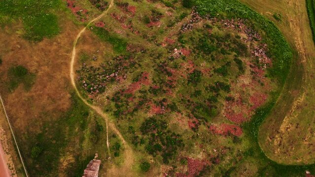 Aerial view of father and a son exploring the Bomarsund castle ruins, in Aland, Finland - high angle, drone shot