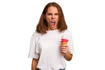 Young caucasian woman holding an ice cream isolated screaming very angry and aggressive.