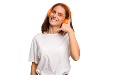 Young caucasian woman listening to music with headphones isolated showing a mobile phone call gesture with fingers.