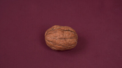 Closeup photo of a walnut seed in wooden bowl. Food that is good for brain and lower risk of heart disease.