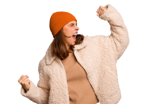 Young caucasian woman wearing winter clothes isolated raising fist after a victory, winner concept. - Powered by Adobe