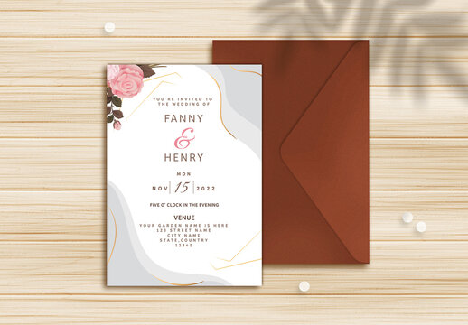 Wedding Invitation or stationery mockup  with envelope, pearls, and leaves shadow on wooden background.