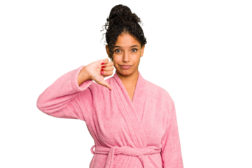 Young brazilian woman wearing a pink bathrobe isolated showing a dislike gesture, thumbs down. Disagreement concept.