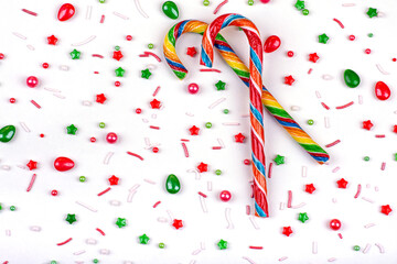 Christmas background of colorful candies, cane lollipops on a white background, close-up