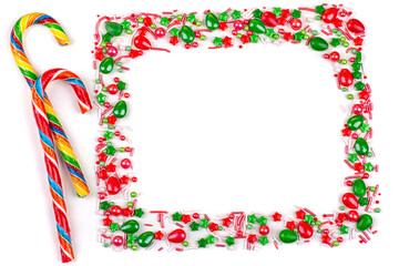Frame of Christmas colorful candies, cane lollipops, on a white background, close-up, copy space