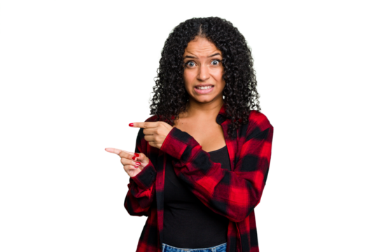 Young cute brazilian woman isolated shocked pointing with index fingers to a copy space.