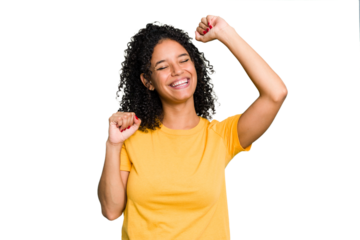 Young cute brazilian woman isolated celebrating a special day, jumps and raise arms with energy.