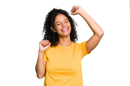 Young cute brazilian woman isolated celebrating a special day, jumps and raise arms with energy.