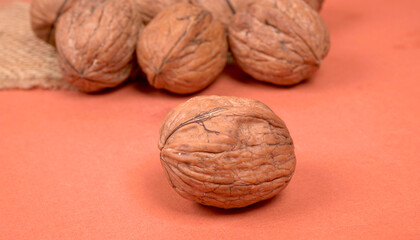 Closeup photo of a walnut seed in wooden bowl. Food that is good for brain and lower risk of heart disease.