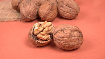 Closeup photo of a walnut seed in wooden bowl. Food that is good for brain and lower risk of heart disease.