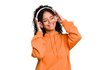 Young brazilian woman listening to music with headphones isolated