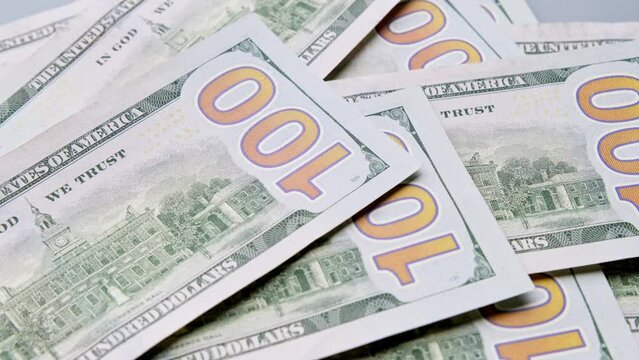 Counting dollar bills. Unrecognizable person calculating cash dollars indoors. Concept of investment. Money counting. Hundreds usd. Financial operations. Close-up in 4K, UHD