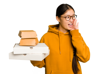 Young student asian woman holding a takeaway food isolated shouting and holding palm near opened mouth.