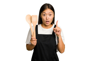 Young asian cook woman isolated having some great idea, concept of creativity.