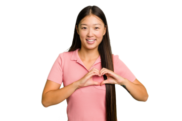 Young Asian woman isolated smiling and showing a heart shape with hands.