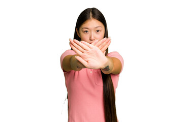 Young Asian woman isolated doing a denial gesture