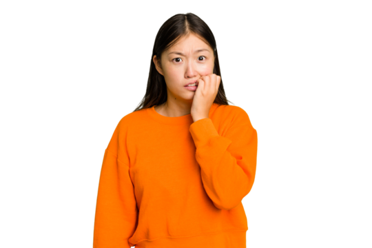 Young Asian woman isolated biting fingernails, nervous and very anxious.