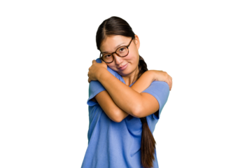 Young Asian woman isolated hugs, smiling carefree and happy.