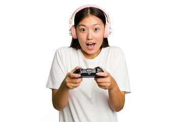 Young asian gamer woman playing with a game controller and headphones isolated © Asier