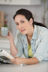 cheerful woman is holding a cup