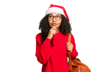 Young african american student woman wearing a christmas hat isolated looking sideways with doubtful and skeptical expression.