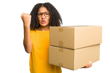 Young african american woman moving to other house while picking up a box full of things isolated showing fist to camera, aggressive facial expression.