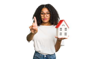 Young african american woman moving to a new home while picking up a box full of things isolated showing number one with finger.