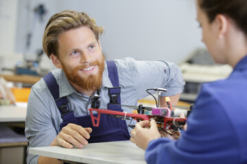 men working together in a drone factory