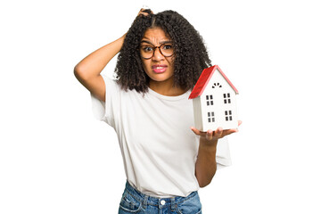 Young african american woman moving to a new home while picking up a box full of things isolated...
