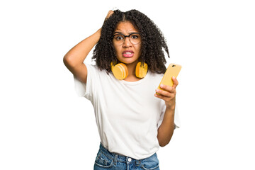 Young african american woman listening to music with yellow headphones isolated being shocked, she has remembered important meeting. - Powered by Adobe