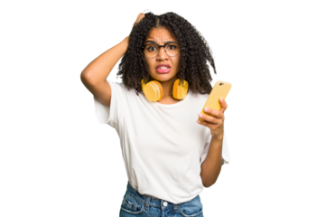 Young african american woman listening to music with yellow headphones isolated being shocked, she has remembered important meeting.