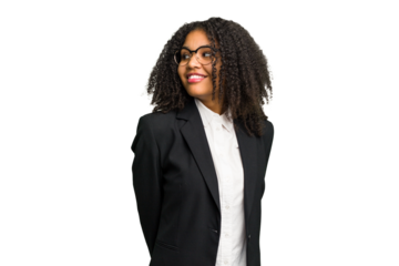 Young african american business woman isolated looks aside smiling, cheerful and pleasant.
