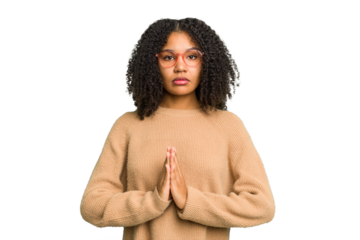 Young african american woman isolated praying, showing devotion, religious person looking for divine inspiration.