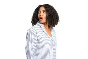 Young african american woman isolated looks aside smiling, cheerful and pleasant.