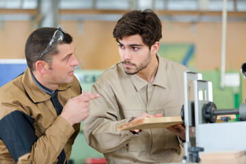 two men assembling product in carpentry workshop