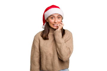Young caucasian woman celebrating christmas wearing a santa hat isolated biting fingernails, nervous and very anxious.