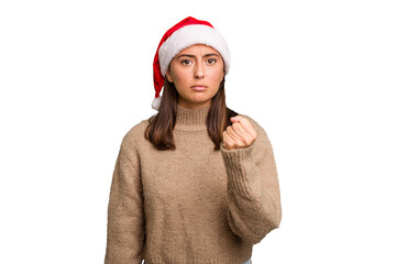 Young caucasian woman celebrating christmas wearing a santa hat isolated showing fist to camera,...