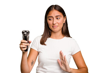 Young caucasian woman holding a razor isolated