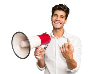 Young caucasian man holding megaphone isolated pointing with finger at you as if inviting come...