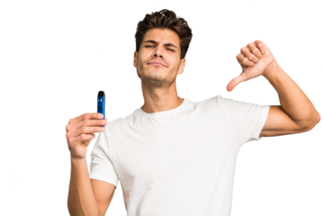 Young caucasian man holding an electronic cigarette isolated feels proud and self confident, example to follow.