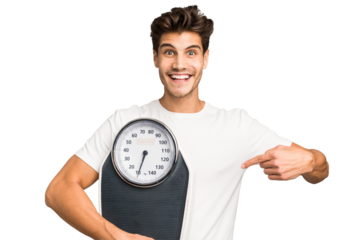 Young caucasian man holding a scale isolated smiling and pointing aside, showing something at blank space.