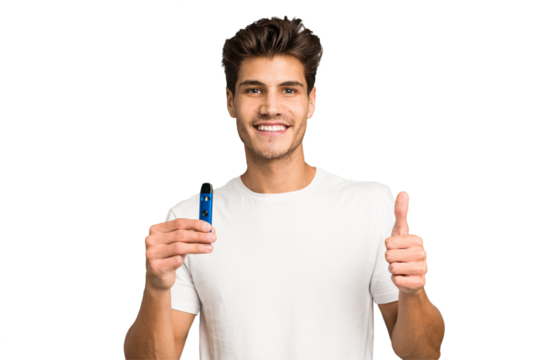 Young caucasian man holding an electronic cigarette isolated smiling and raising thumb up