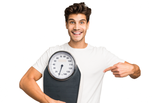 Young caucasian man holding a scale isolated smiling and pointing aside, showing something at blank space.